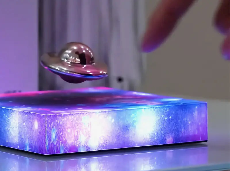 A finger about to tap the floating UFO