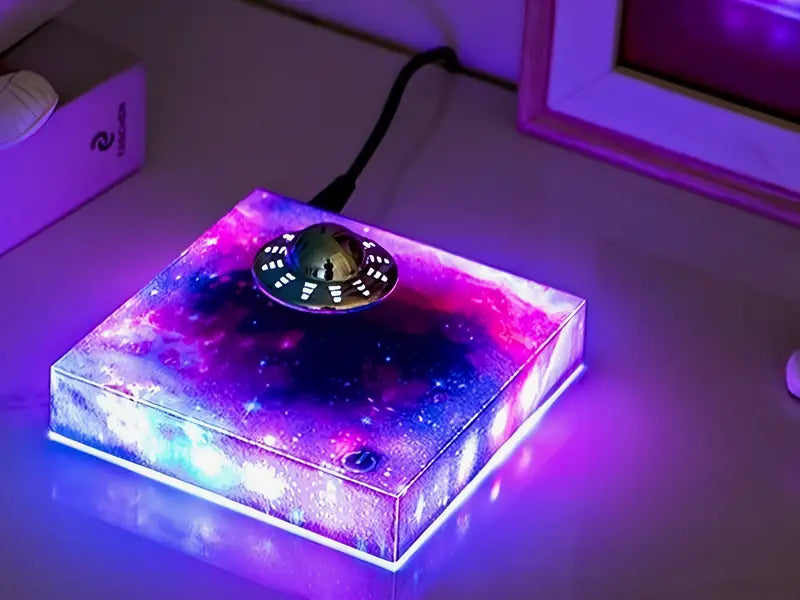 The UFO lamp glowing on a desk at night